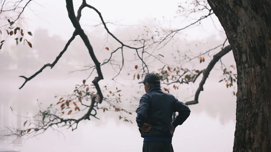 An elderly person sitting peacefully in a garden, reflecting and finding moments of calm during the grieving process